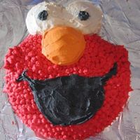 Elmo Pretty simple. Round cake pan plus cupcakes for eyes and nose.