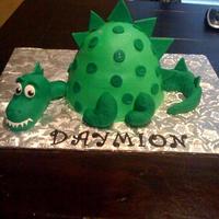 Dinosaur Wonder Mold Super easy cake! Used the wonder mold. Tail and legs are MMF. Carved cake covered in fondant for the head.