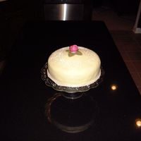 Swedish Princess Cake genoise cake, layers of raspberry, pastrycream, and whipped cream, covered in marzipan; purchased gumpaste rose