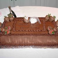 Groom's Cake Chocolate on chocolate with chocolate covered strawberries. Groom tuxedo strawberry and bride white cholcolate bride dipped in edible...