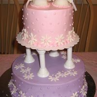 Girl Baby Shower Cake has fondant daisies and booties, etc.