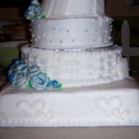 70S_Dance_Jan_262008_078.jpg the top tear is suposed to be tilted. there are white fondont roses with blue sprkle dusted tips. and each tear is decorated differantly.