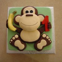 Going Bananas!! Square cake with monkey. Monkey is made of Rice Krispies and covered in chocolate fondant.