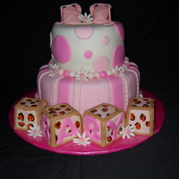 Baby Shower Client wanted a million things incorporated in one cake. Therefore we have booties, blocks, leopard print and flowers. lol