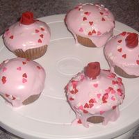 Cupcakes! WASC cake with marshmallow fluff icing. The icing was intended to be the filling but it worked better as an icing. Fondant roses on top and...
