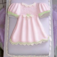 Baby Doll Dress Baby Shower Cake This cake was done using a t-shirt pan and modifying it . It is all fondant .