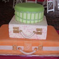 Suitcase Wedding Cake all decorations done in fondant including handles, buckles and roping. Monogram piped with royal, used mat to do design on middle tier