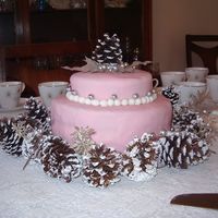 Simple Wedding Celebration Cake Round fondant covered wedding cake with pinecone and synthetic leaf accents