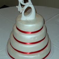 Shimmer Wedding Cake 4 tier round WASC cake with white fondant, airbrushed pearlesense, red ribbon.