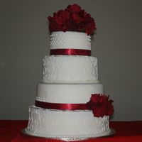 Red/white Wedding First wedding cake, simple red and white with synthetic hydrangeas, covered in MMF and iced in RI and butter cream.