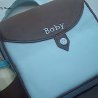 Blue & Brown Diaper Bag This is my very first baby shower cake...so much fun. White cake covered in fondant and a chocolate baby bottle.