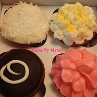 Cupcake Variety 1 Top left- lemon cake with coconut filling and cream cheese icing, topped w/ shredded coconut.Top right - Lemon cake with bettercreme icing...