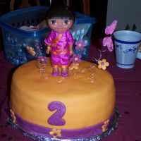 Dora, World Traveler Birthday cake for a 2 year old girl. Yellow cake filled with guava and covered with fondant. Tried to match the color of the fondant with...