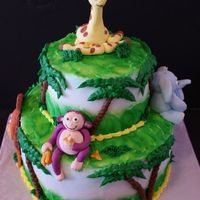 Wild Safari This jungle cake was made for a little girls first birthday party. The animals are crafted using fondant. Their face details are drawn with...