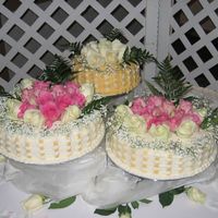 1St Wedding Cake White cake with mocha cream filling. Buttercream icing in basketweave pattern with fresh roses on top.