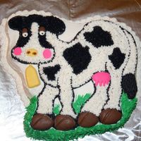 Cow Cake This cake was made for a friend's birthday. The eyes, nose, cheeks, bell, utters and hooves are all made of chocolate.