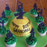 Witch Over The Moon Round "moon" cake in center surrounded by cupcakes with witch, black cat, jack-o-lantern and haunted house sillouette decorations...