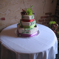 Hexagon Gluten Free And Vegan Wedding Cake This cake was fun and colorful. The bride wanted the colors to match her family engagement ring. The greens added a bit of a 3D feel to the...