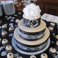 Black And White Gluten Free Wedding Cake This black and white cake is 100% gluten free. We loved the cake and the addition of some cupcakes around the bottom.