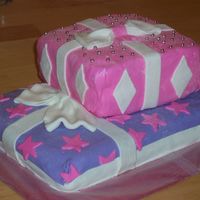 Girls Gift-Wrapped Cake Yellow cake with raspberry filling and buttercream icing covered in fondant and dragee decorations.