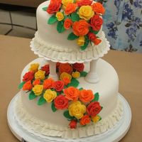 Course 3 Final Cake Satinice fondant with red, yellow and orange fondant roses. Top cake is chocolate fudge cake and bottom is yellow pound cake. What a fun...