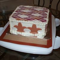 Side View I couldn't figure out how to make the argyle pattern so down on two sides of the cake so I put the fleur de lis on two sides lol.