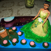 Princess And The Frog Based this cake off of a picture from a movie poster. Marble choc and vanilla cake w/buttercream. Fondant frog and dress. Wondermold pan...