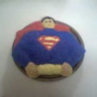 Superman Cake This is a superman cake I made at home for practice. It is a yellow cake with buttercream icing.