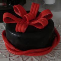 Black Fondant With Red Fondant Bow This is my first ever attempt working with fondant! The cake is vanilla, colored red, covered with buttercream frosting, black fondant and...