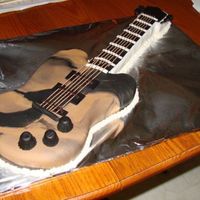 Electric Guitar Electric guitar made with marblized fondant. Whole wheat spagetti for the strings. Still learning ... a long way to go yet. Still fun.