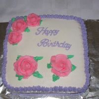 Birthday Cake Chocolate cake with strawberry buttercream filling and buttercream icing and decorations.