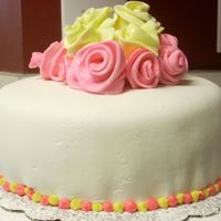Pink/yellow Roses Pink and yellow roses out of fondant with white fondant. Strawberry cake. First time using fondant.