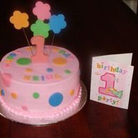 Flowers And Dots Buttercream base with fondant accents. Candy melts "1".