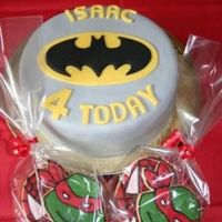 Batman Cake Cake and biscuits for my sons 'SuperHero' themed fourth birthday party. Batman logo is royal icing on sugarpaste and biscuits are...