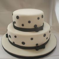 Black And White 6'9' cakes covered in fondant. Bows, borders and dots are fondant. Cake circle covered in fondant, border is fabric. Customer was...