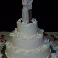 Rose Petals Silk rose petals adorn this simple round wedding cake.