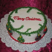 022706_128.jpg Dark chocolate cake with mint buttercream icing. Molded chocolate ornaments, buttercream pine boughs, and bead border. The family loved it...