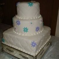 Fondant Covered Daisy Wedding Cake! 6, 8, rounds and 12 inch squared wedding cake covered in fondant with fondant daisies!