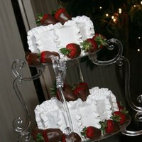 Wedding Cake With Choco Covered Strawberries! Decorated with buttercream icing and chocolate covered strawberries!