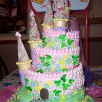 Alyssa's Princess Castle Cake Stacked tiers of almond, chocolate and raspberry marbled rum cakes torted and filled with cream cheese icing. Tops covered in marshmellow...