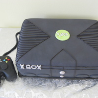 X-Box Fondant decorations with royal icing lining. Rice cereal treats as hand-held device.