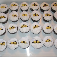Mummy Cupcakes with ribbon tip used to make mummy wraps. Icing is buttercream