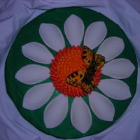 Sunflower With Butterfly buttercream covered cake with fondant leaves and butterfly.