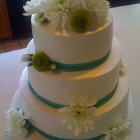 Chrystin's Bridal Shower White buttercream icing, ribbon and white flowers.