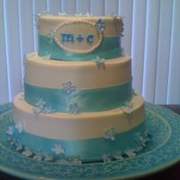 My Best Friends Wedding White buttercream, blue ribbon, and blue sugar flowers.