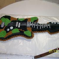 Camo Guitar This a grooms cake I did for our adopted daughter and her new hubby iit is a camo guitar. I did the pattern myself and the strings are made...