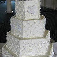 Hex Shape Cake Each side a mixture of buttercream work and sugar flowers. Lily of the valley topper is gumpaste.