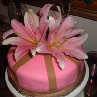 Fresh Flowers This cake is covered in Pink and brown fondant and topped with fresh lillies