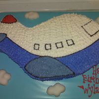 Airplane Cake 2 year old's birthday cake. I cut the shape out of a sheetcake, then drew the design. All buttercream, fondant clouds. This was a fun...