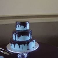 Blue & Brown This blue cake was covered with 71% dark chocolate ganache to match the Bride's color scheme